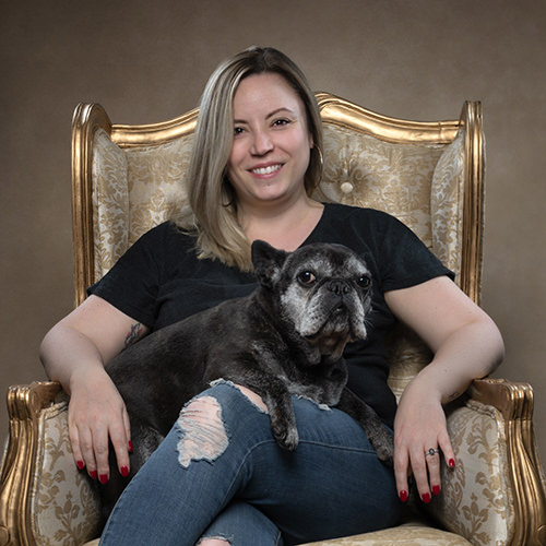 Belinda Richards Profile Image sat on chair with dog on lap